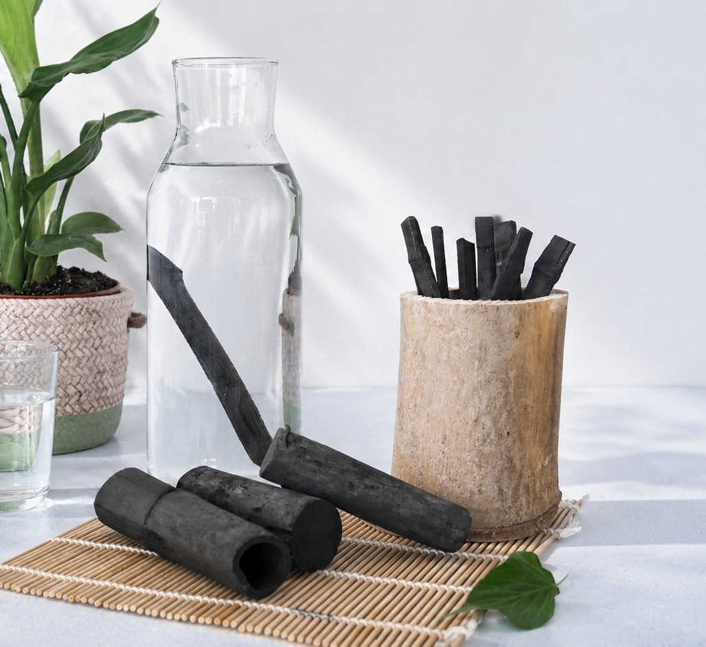 A bamboo charcoal stick placed in a carafe of clear water
